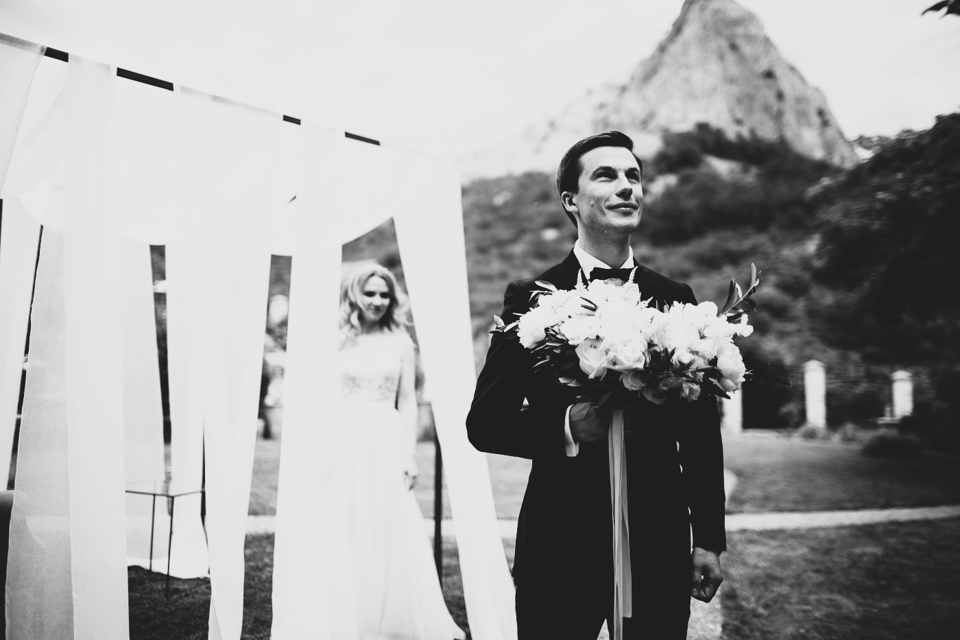 homme de dos avec la mariée derrière pour le first look de mariage